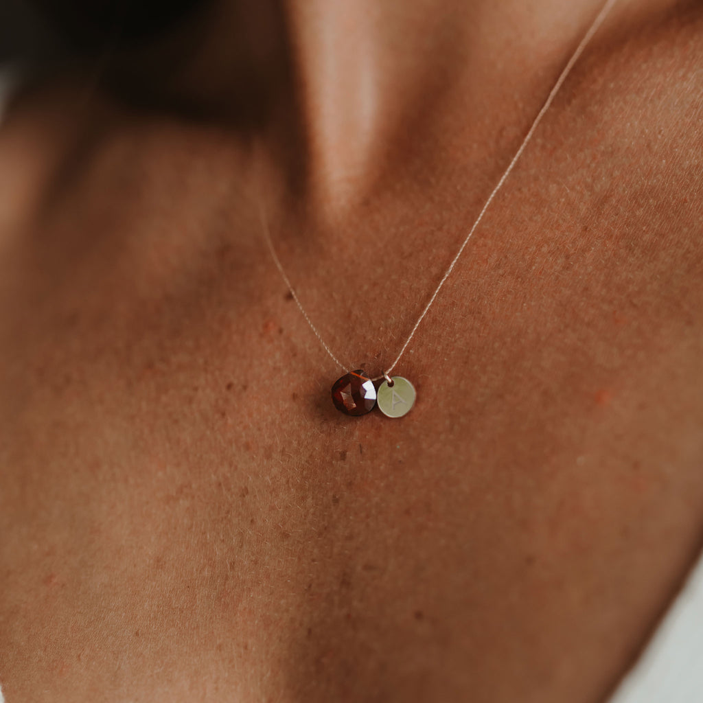 Wanderlust Life Ethically Handmade jewellery made in the UK. Minimalist gold and fine cord jewellery. january birthstone, garnet fine cord necklace. Personalised garnet necklace with gold personalised tag jewellery, handmade in the UK.