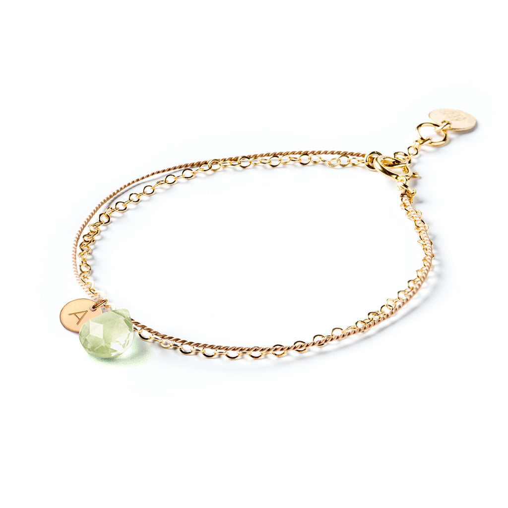 Wanderlust Life Ethically Handmade jewellery made in the UK. Minimalist gold and fine cord jewellery. february birthstone, gold & silk mint amethyst bracelet personalised with a hand-stamped initial tag. Shop personalised jewellery.