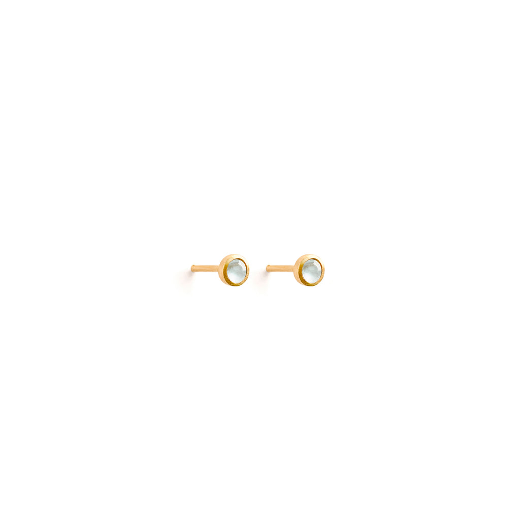 Wanderlust Life Ethically Handmade jewellery made in the UK. Minimalist gold and fine cord jewellery. March birthstone gold stud earrings. Aquamarine gemstone earrings.