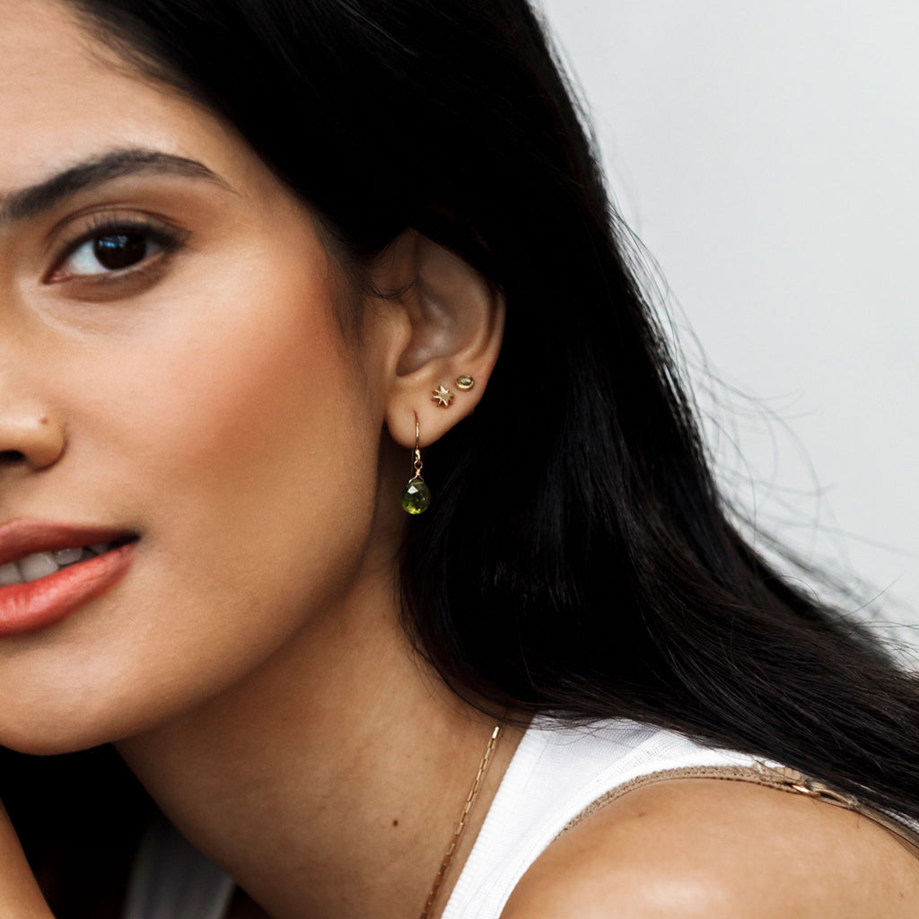 Wanderlust Life Ethically Handmade jewellery made in the UK. Minimalist gold and fine cord jewellery. August birthstone gold stud earrings. Peridot gemstone earrings.