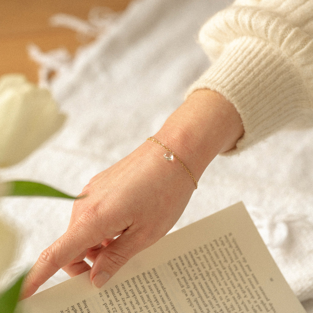 Wanderlust Life Ethically Handmade jewellery made in the UK. Minimalist gold and fine cord jewellery. april birthstone, gold & silk clear quartz bracelet